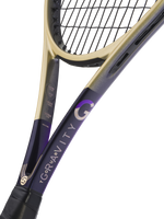 Close-up of a tennis racket showing the throat and part of the frame, with a black and purple body and a gold-colored throat section, set against a solid white background.